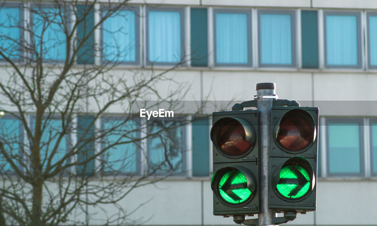 Close-up of stoplight against building