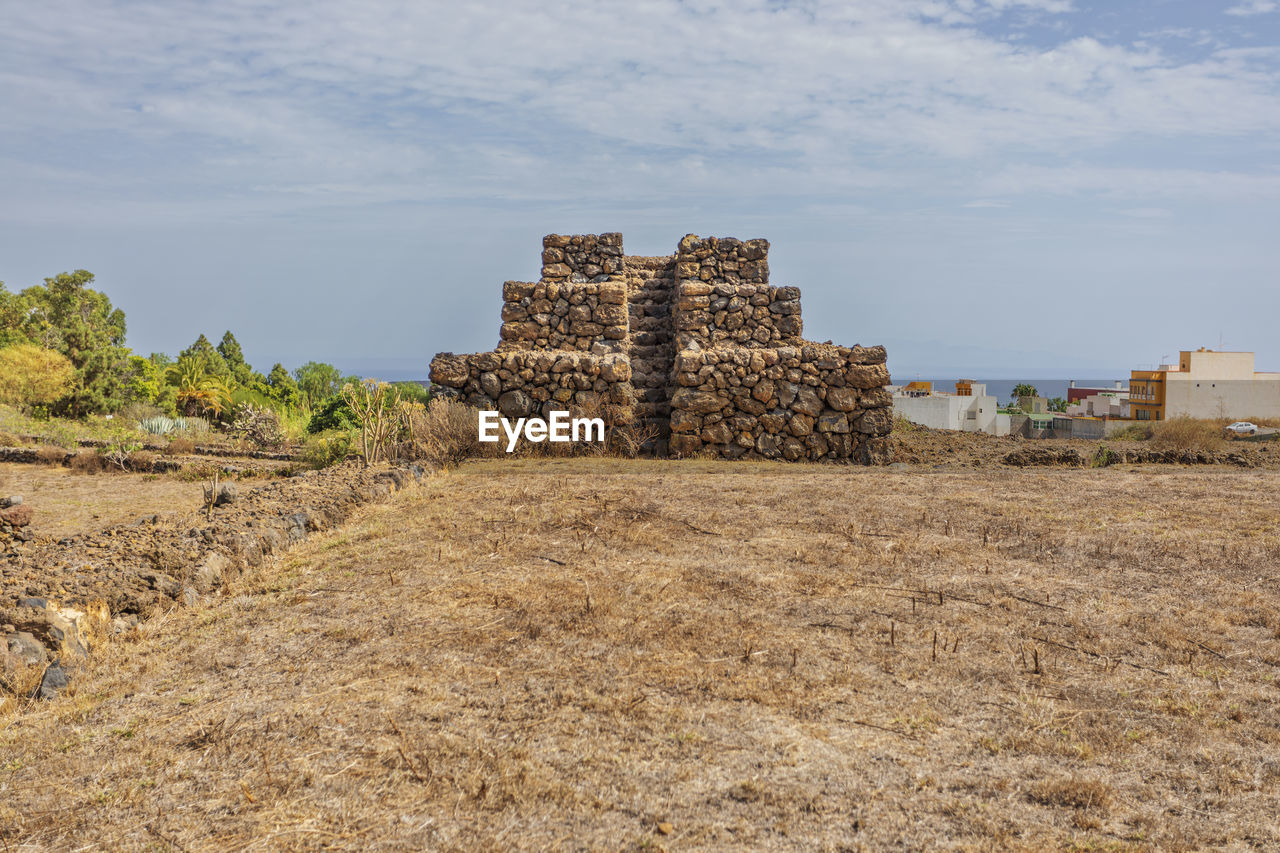 architecture, ruins, history, sky, built structure, the past, ancient, ancient history, nature, archaeological site, cloud, land, building exterior, travel destinations, landscape, old ruin, no people, building, travel, outdoors, ancient civilization, plant, day, rural area, environment, rock, fortification, tourism, old, wall, sand, tree