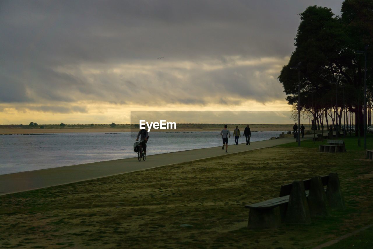 PEOPLE AT BEACH DURING SUNSET