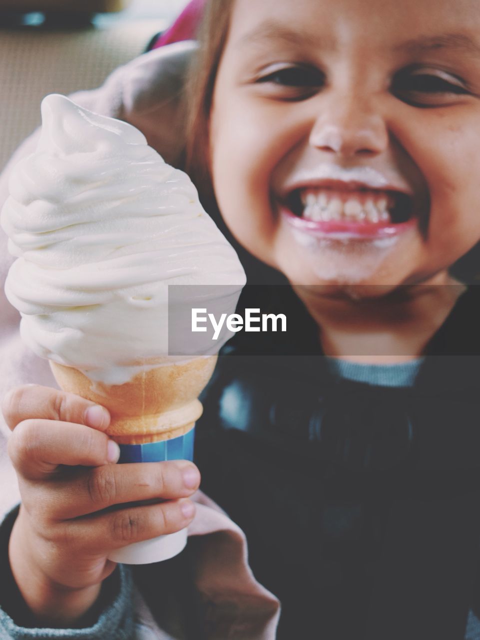 Portrait of happy girl holding ice cream