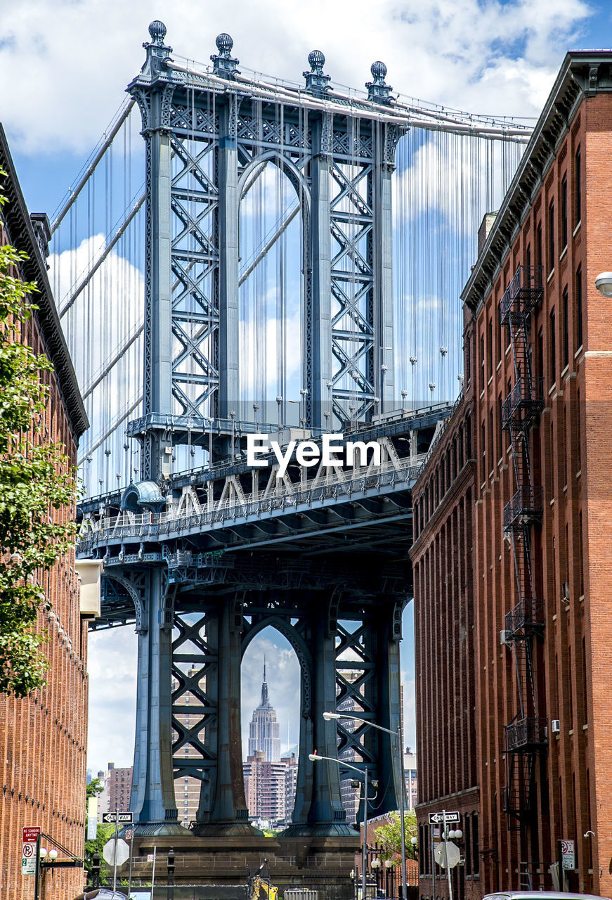 Low angle view of manhattan bridge against sky in city