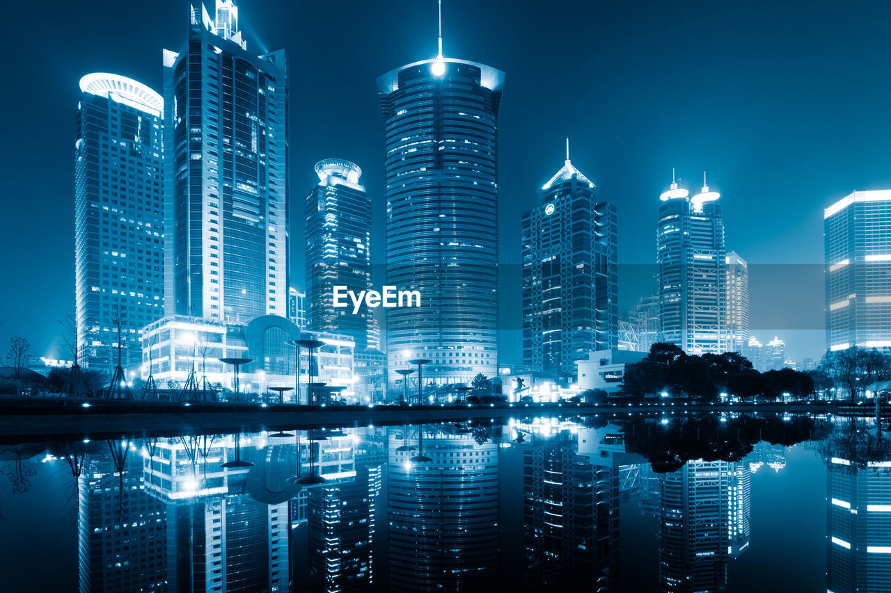 ILLUMINATED BUILDINGS AGAINST SKY AT NIGHT