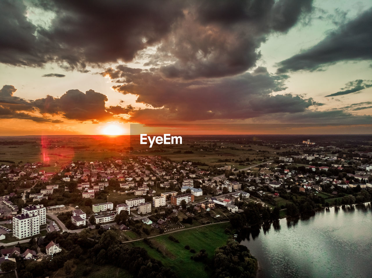 HIGH ANGLE SHOT OF TOWNSCAPE AGAINST SKY DURING SUNSET