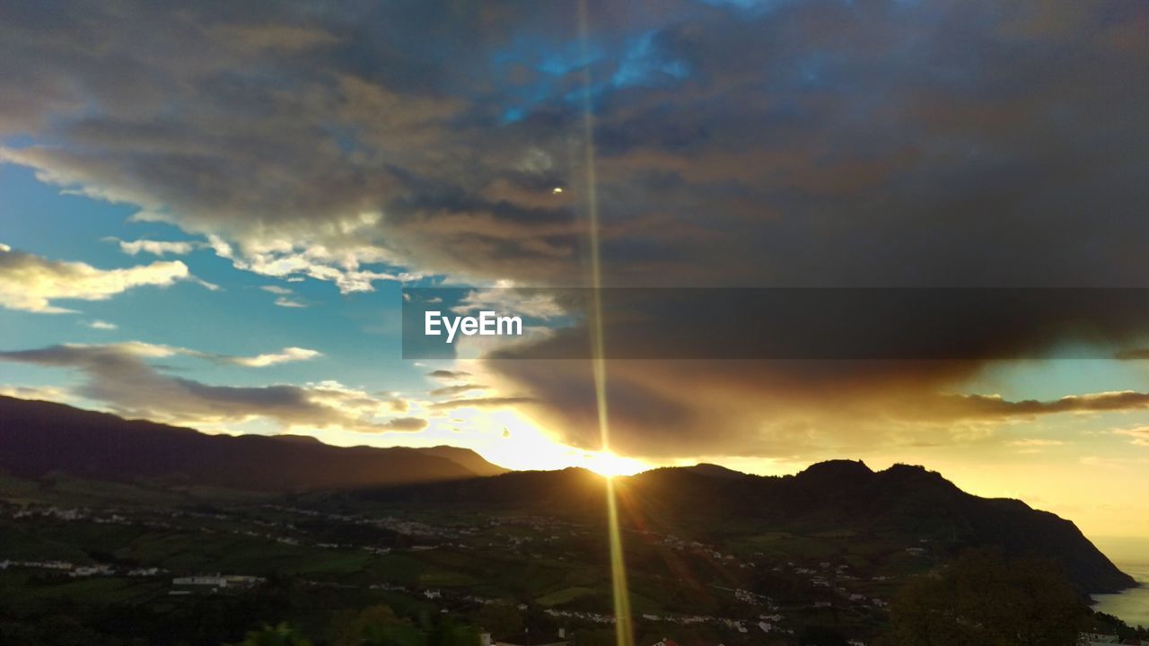 Scenic view of mountains against cloudy sky