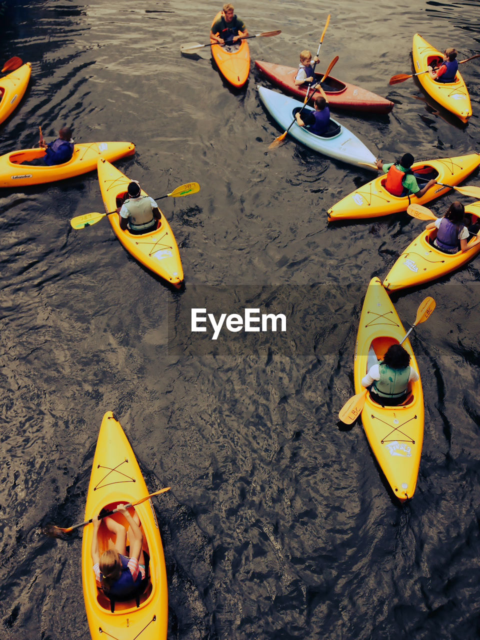 High angle view of people kayaking in sea