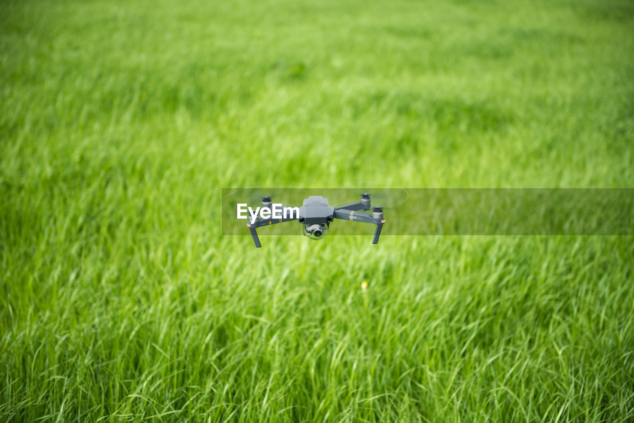 Drone hovering above field