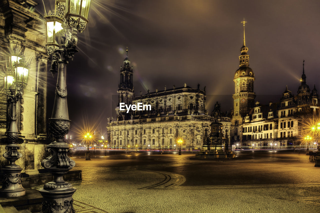 Statue of illuminated city at night