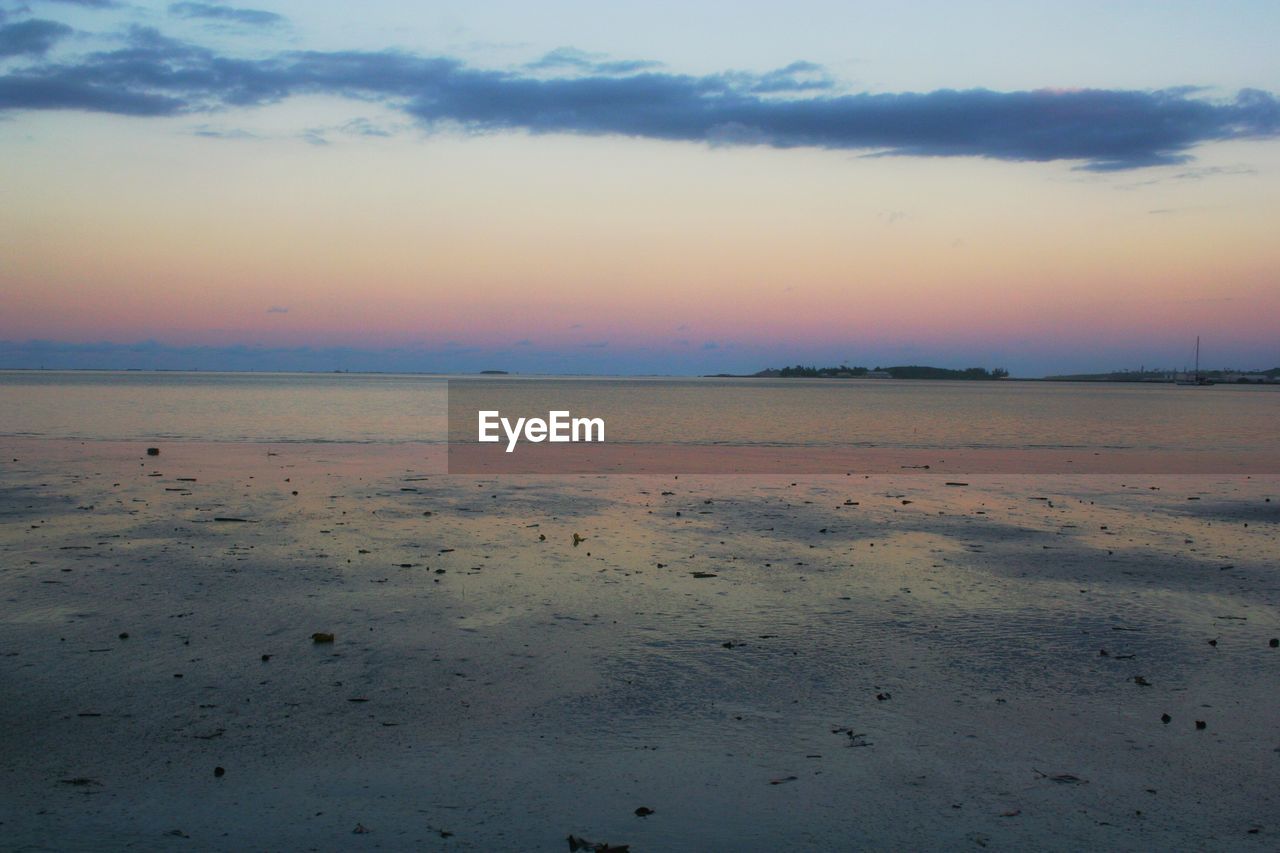 SCENIC VIEW OF SUNSET OVER SEA