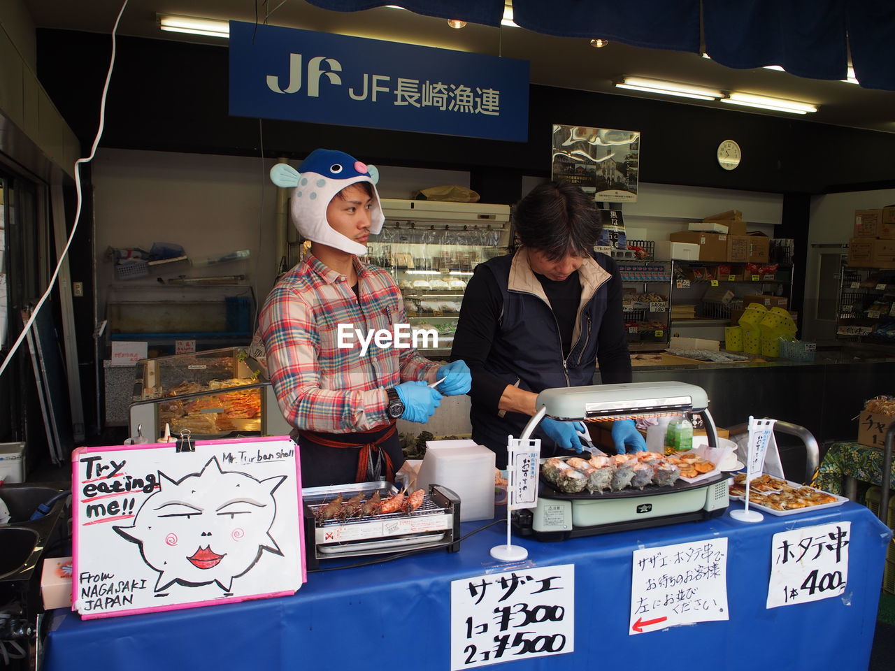 PEOPLE STANDING AT MARKET