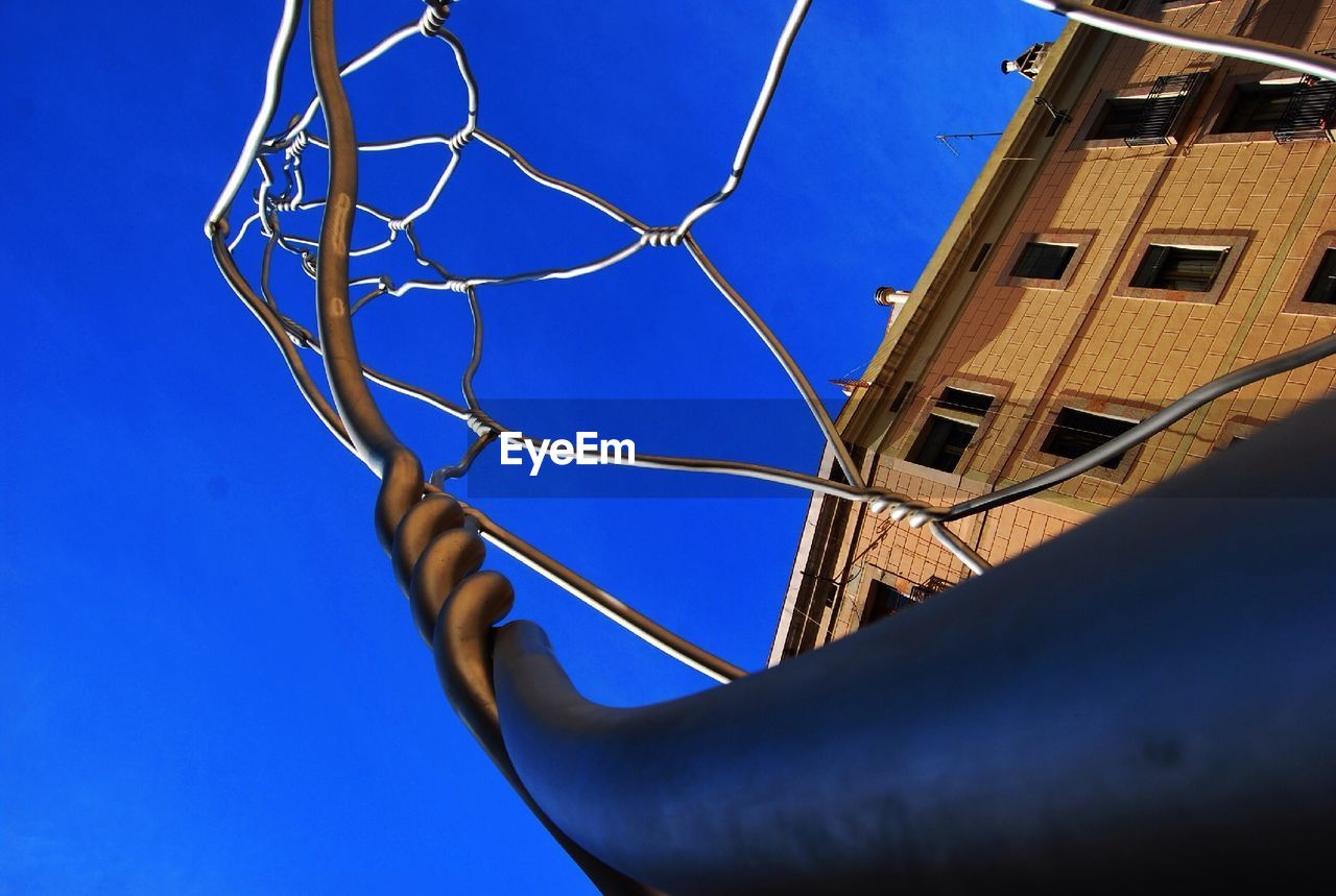 LOW ANGLE VIEW OF BUILDINGS AGAINST CLEAR BLUE SKY