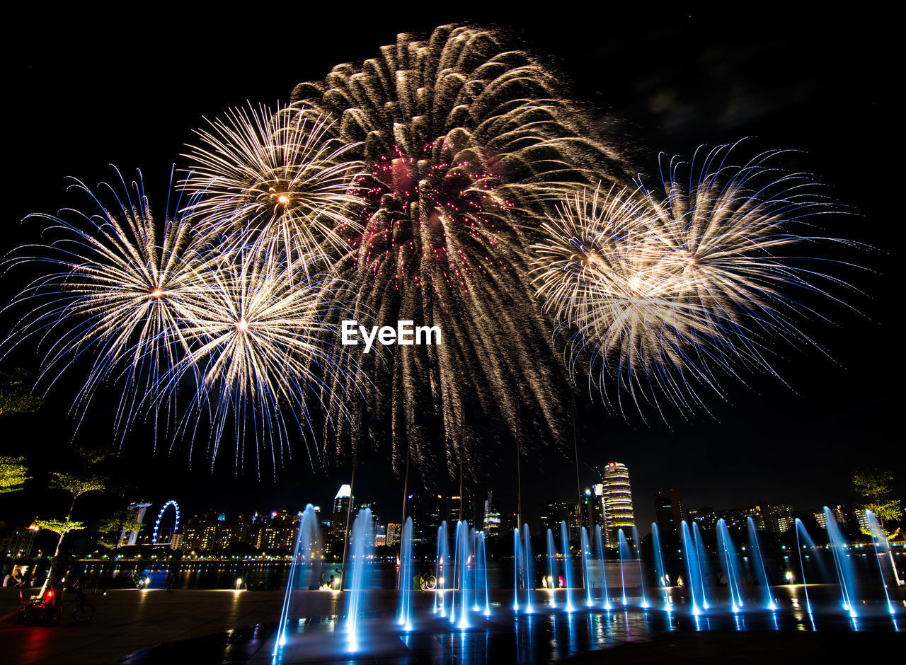 Low angle view of firework display at night