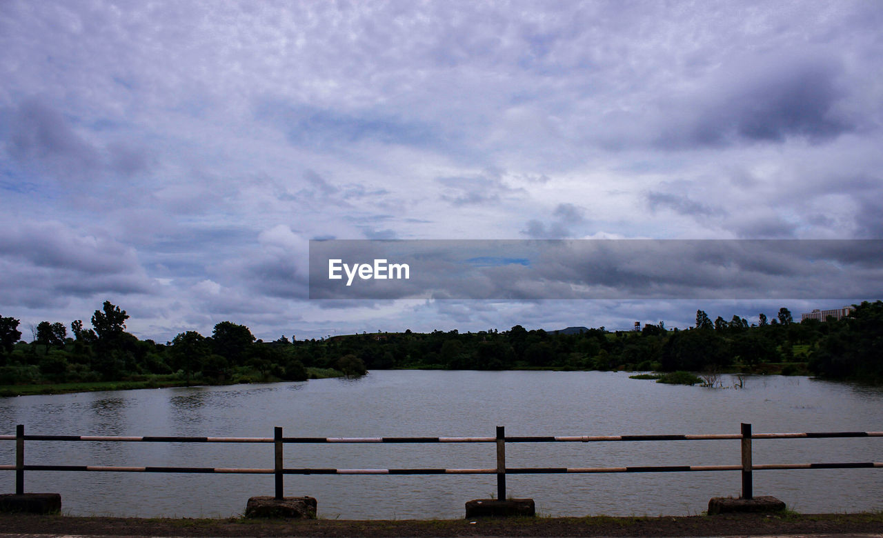 SCENIC VIEW OF CALM SEA AGAINST CLOUDY SKY