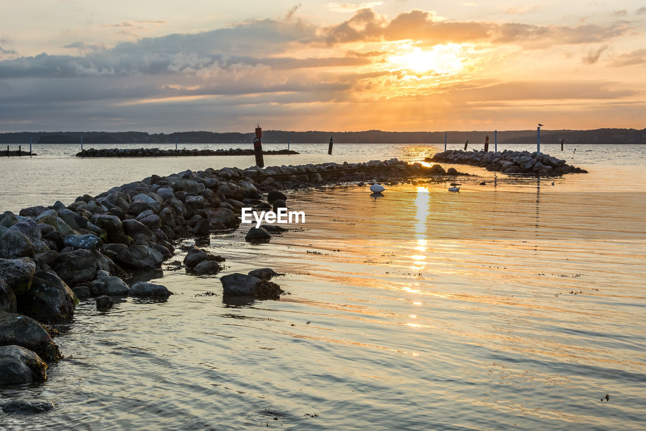 SCENIC VIEW OF SEA AGAINST ORANGE SKY