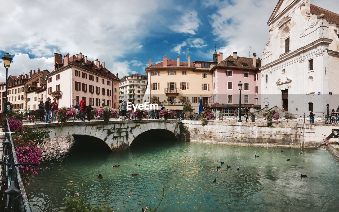 BRIDGE OVER CANAL BY BUILDINGS IN CITY