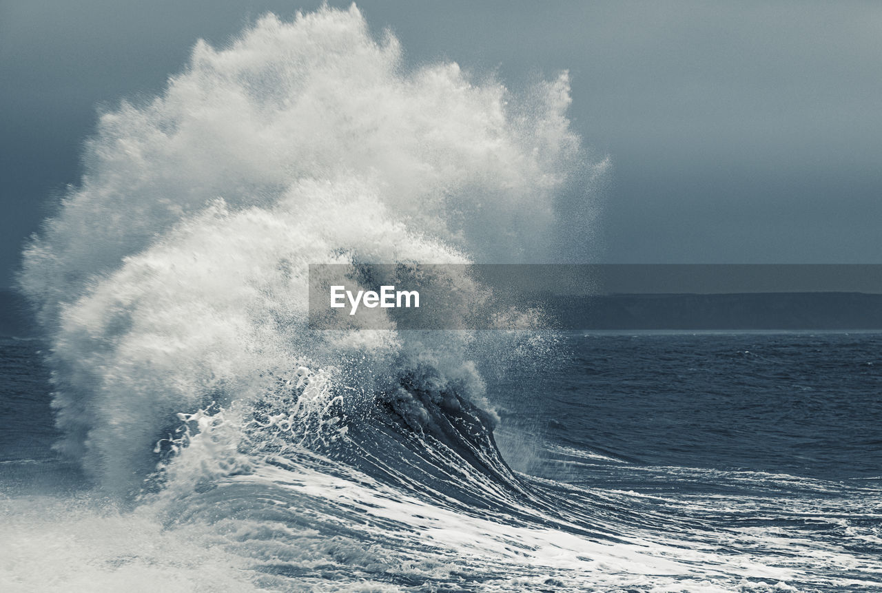 Scenic view of rough sea against sky