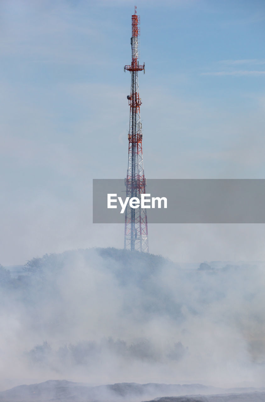 Low angle view of communications tower against sky