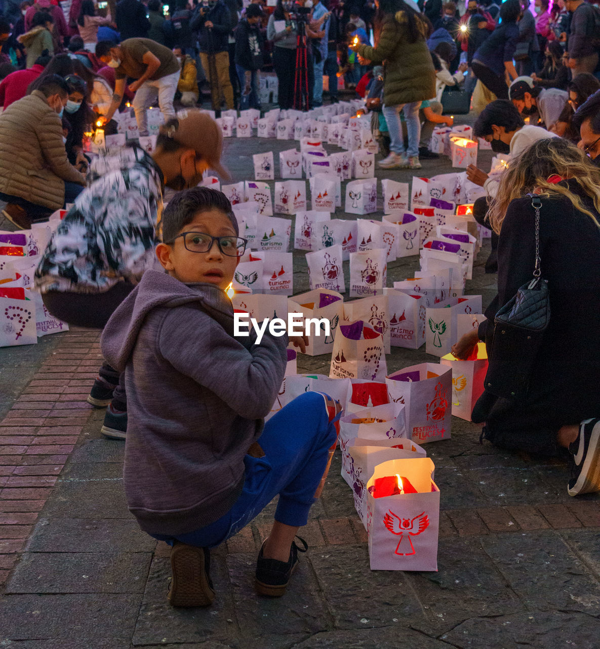 crowd, men, group of people, market, city, childhood, women, street, adult, child, retail, lifestyles, selling, market stall, sitting, celebration, large group of people, architecture, leisure activity, outdoors, business, public space, tradition, religion