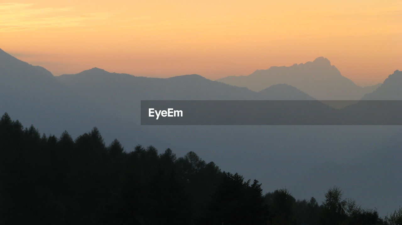 Scenic view of silhouette mountains against sky during sunset
