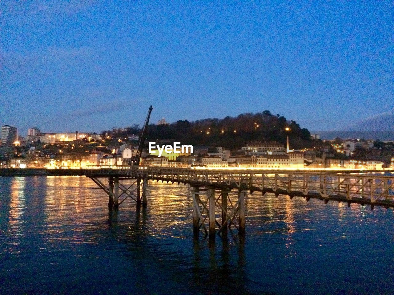 ILLUMINATED BUILDINGS AT WATERFRONT