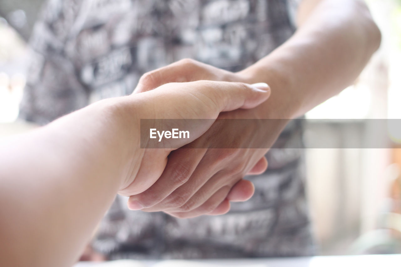 Close-up of people shaking hands