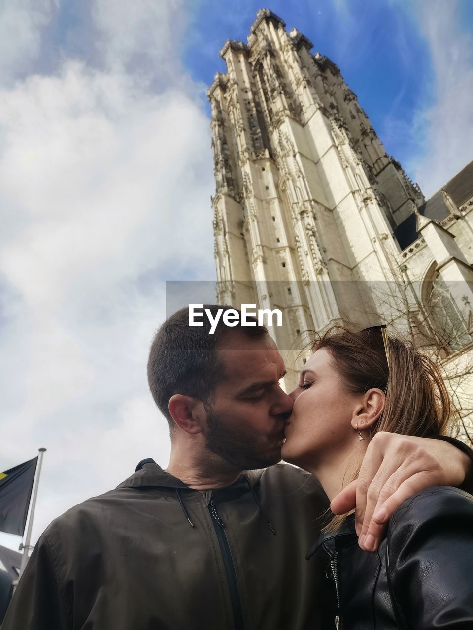 Low angle portrait of couple against sky