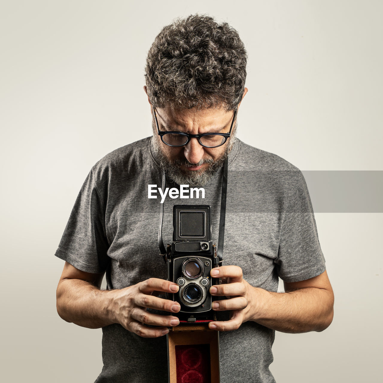 Man holding camera against white background