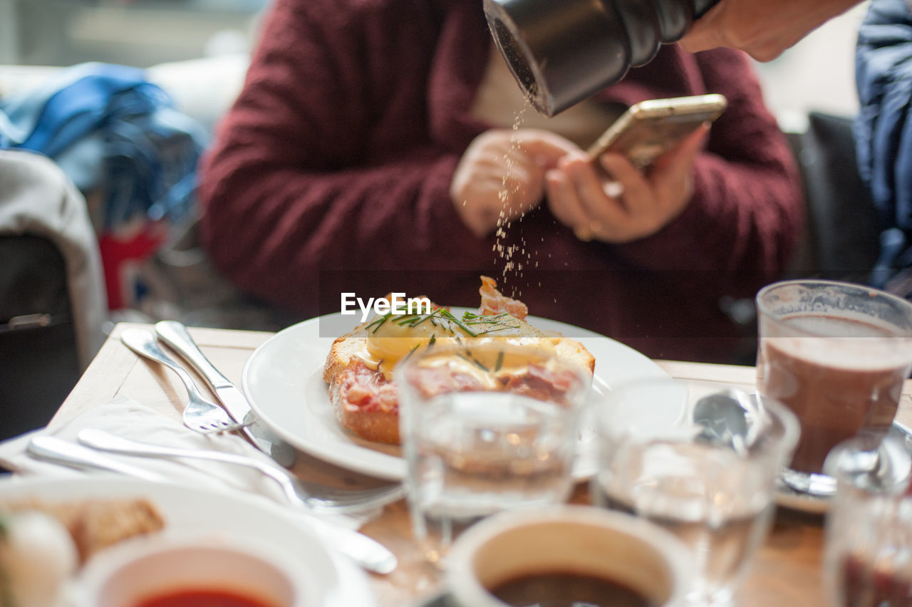 Close-up of seasoning salt on food at restaurant