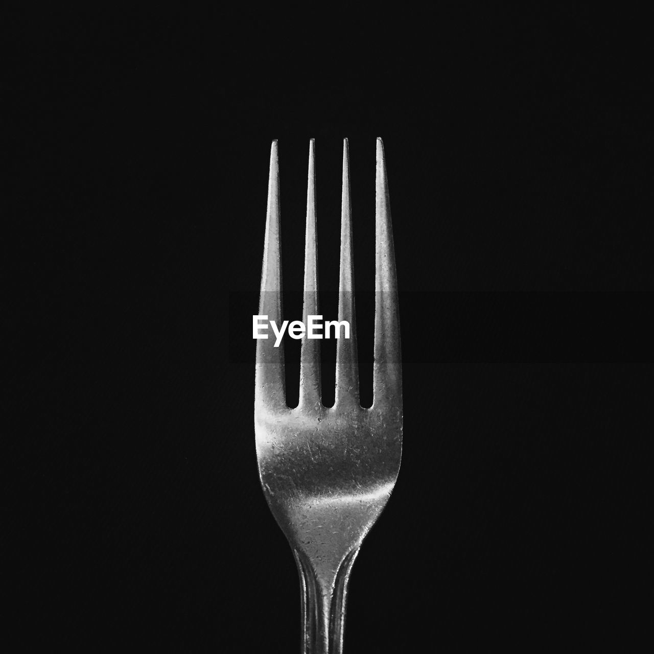Close-up of fork against black background