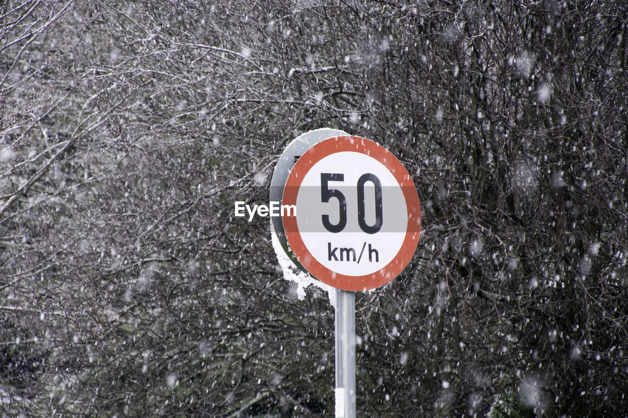 Speed limit sign during snowfall