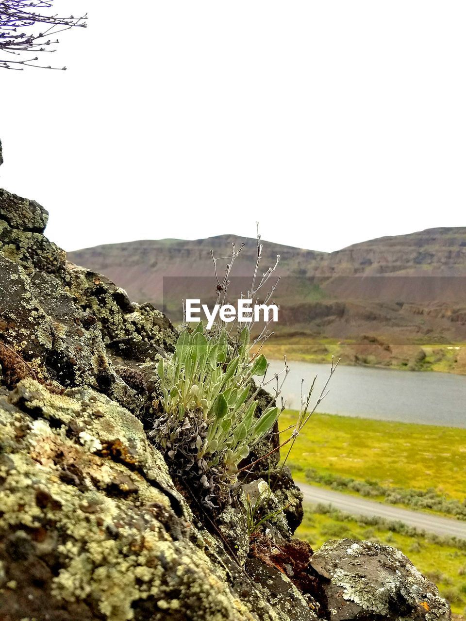 CLOSE-UP OF ROCKS ON MOUNTAIN AGAINST CLEAR SKY