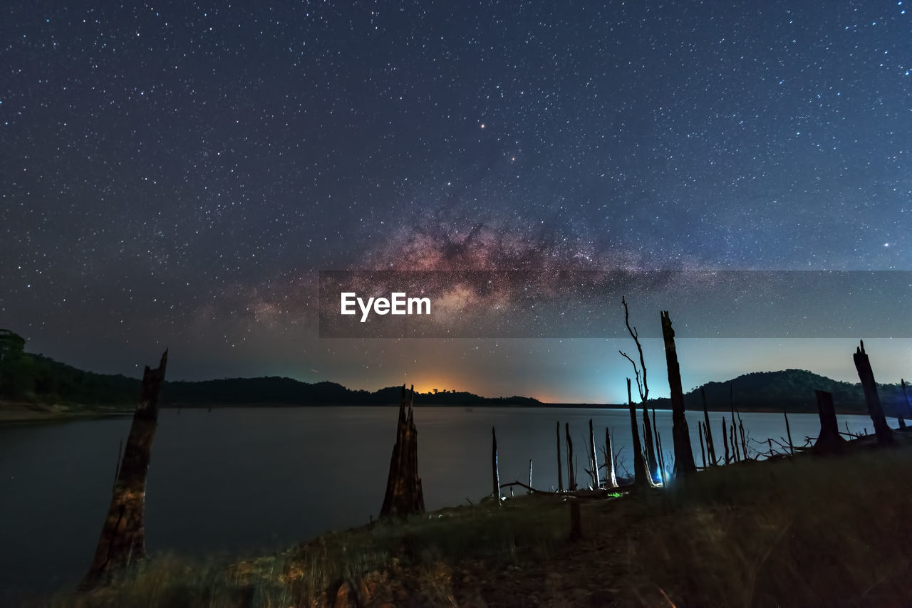 Scenic view of lake against sky at night