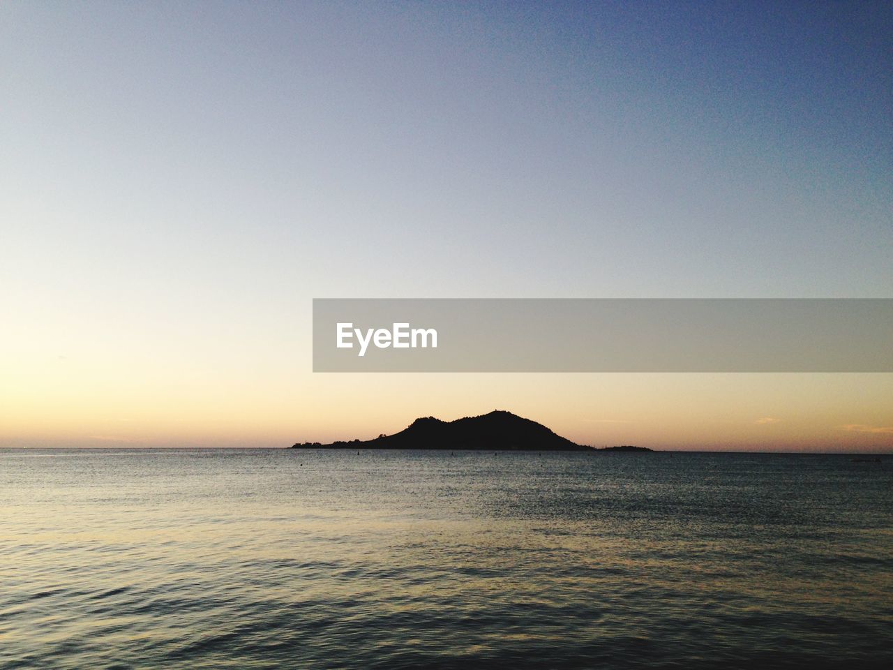 Scenic view of sea against clear sky during sunset