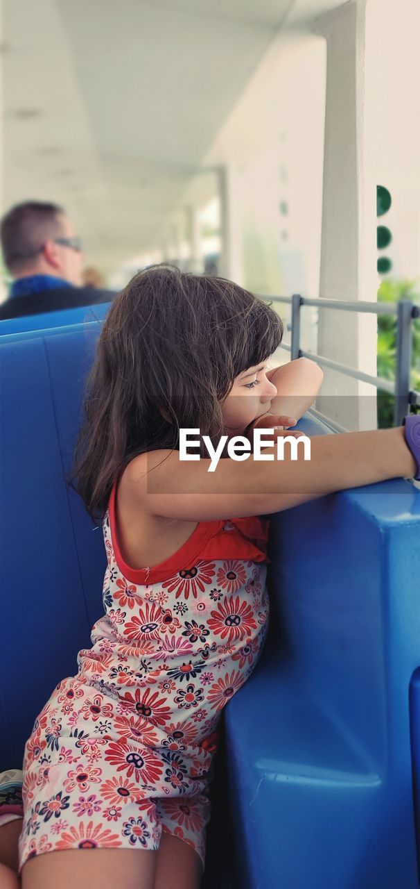 Girl standing on seat