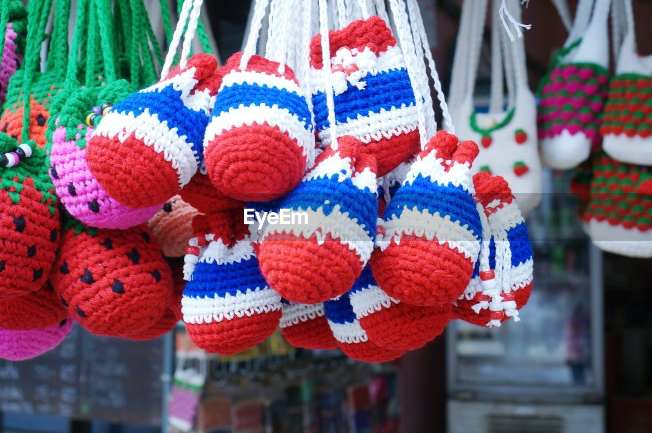 Close-up of multi colored crochets hanging for sale in market