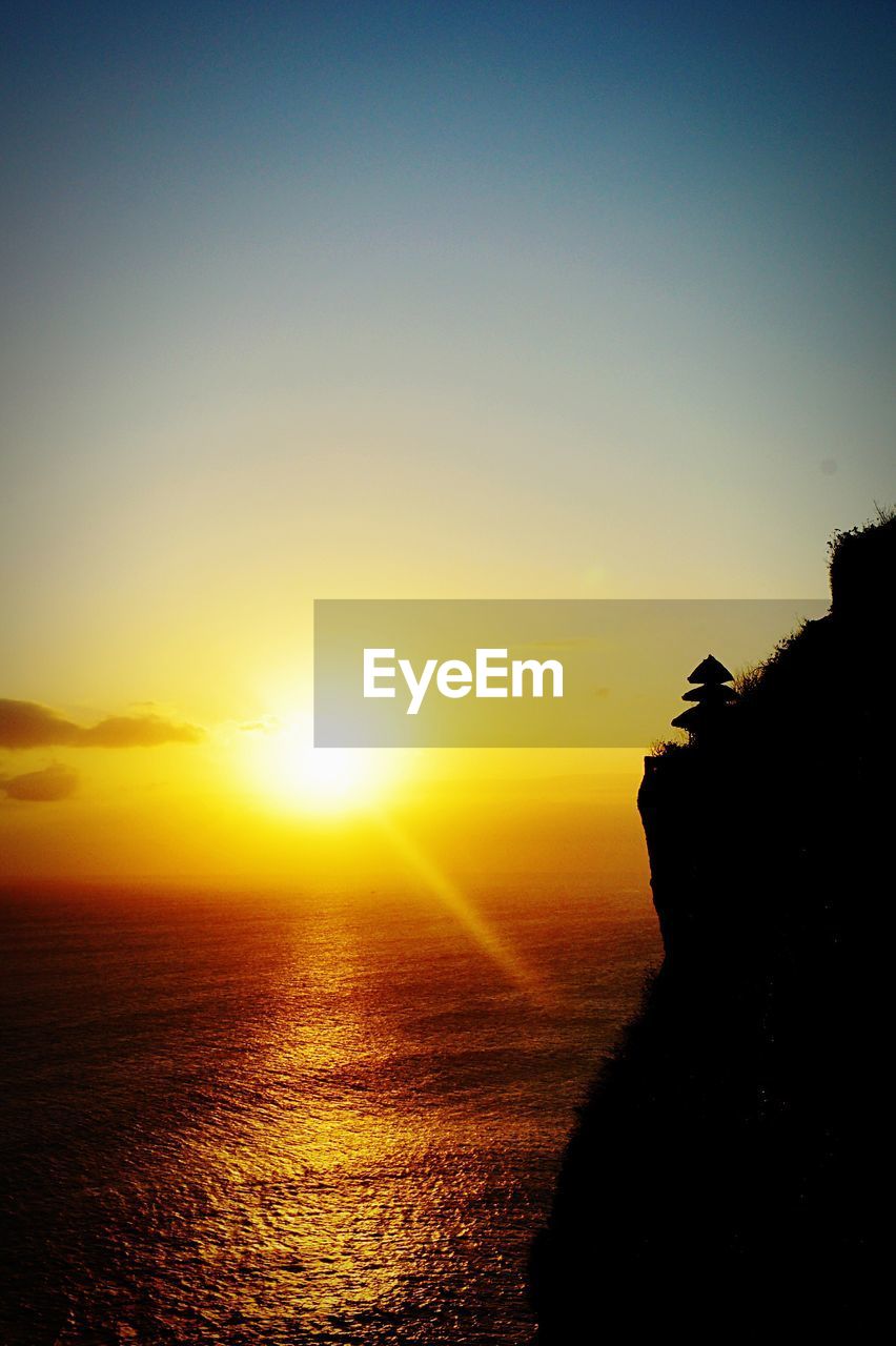 Scenic view of beach against sky during sunset