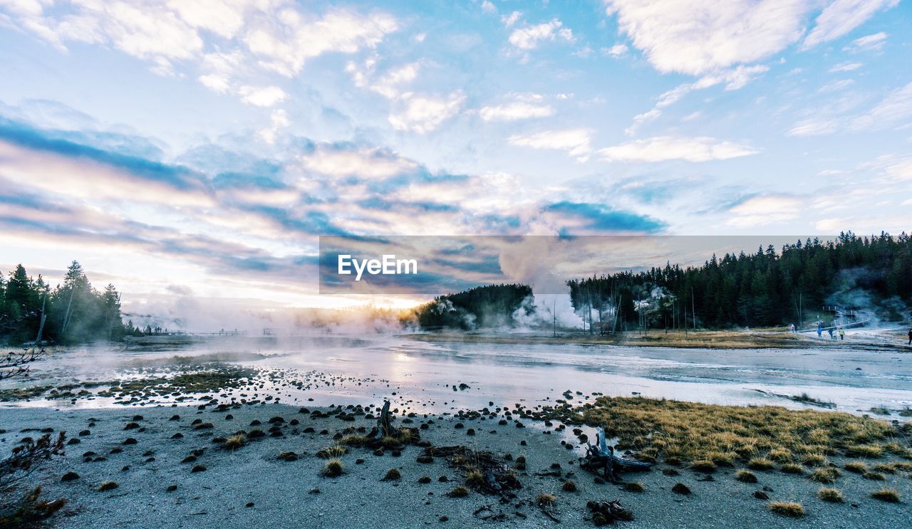 Scenic view of lake against dramatic sky