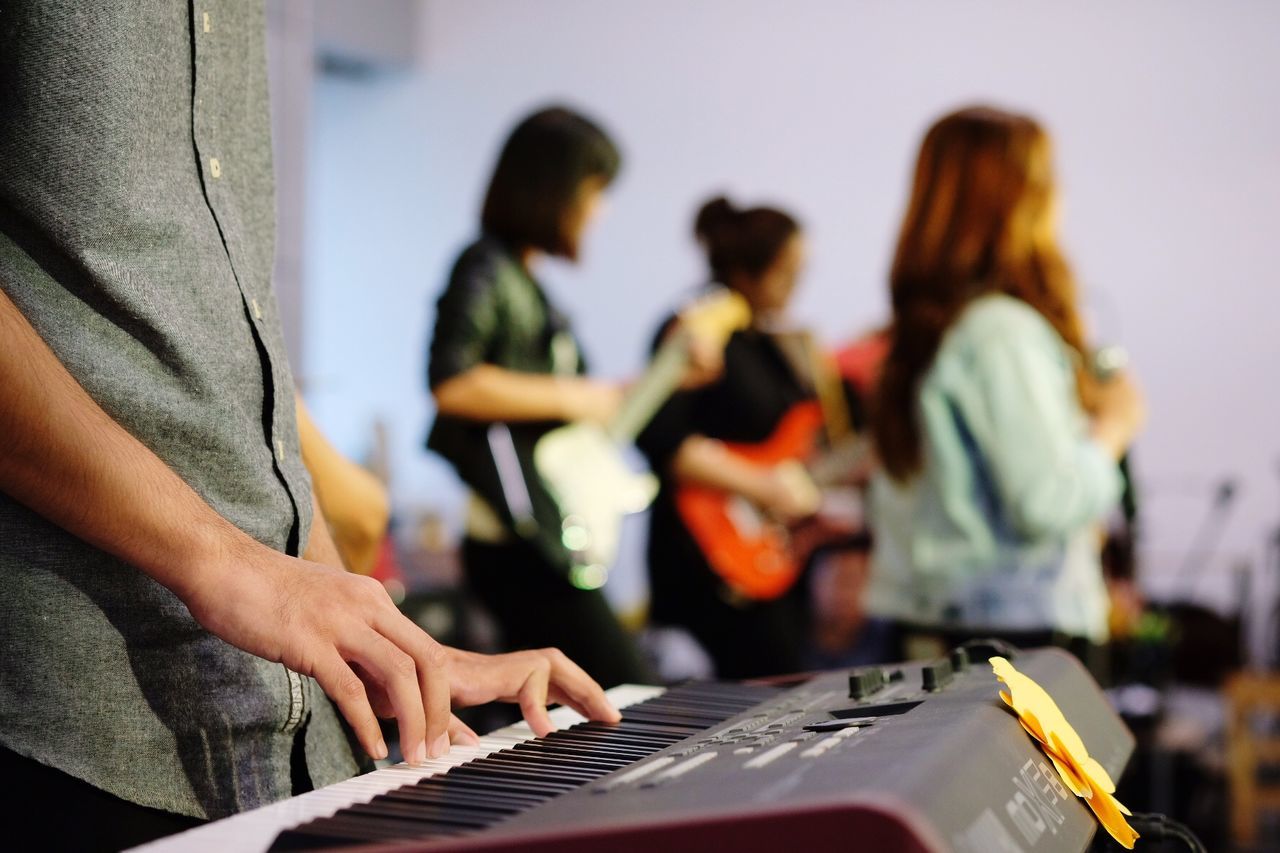 Midsection of woman playing piano