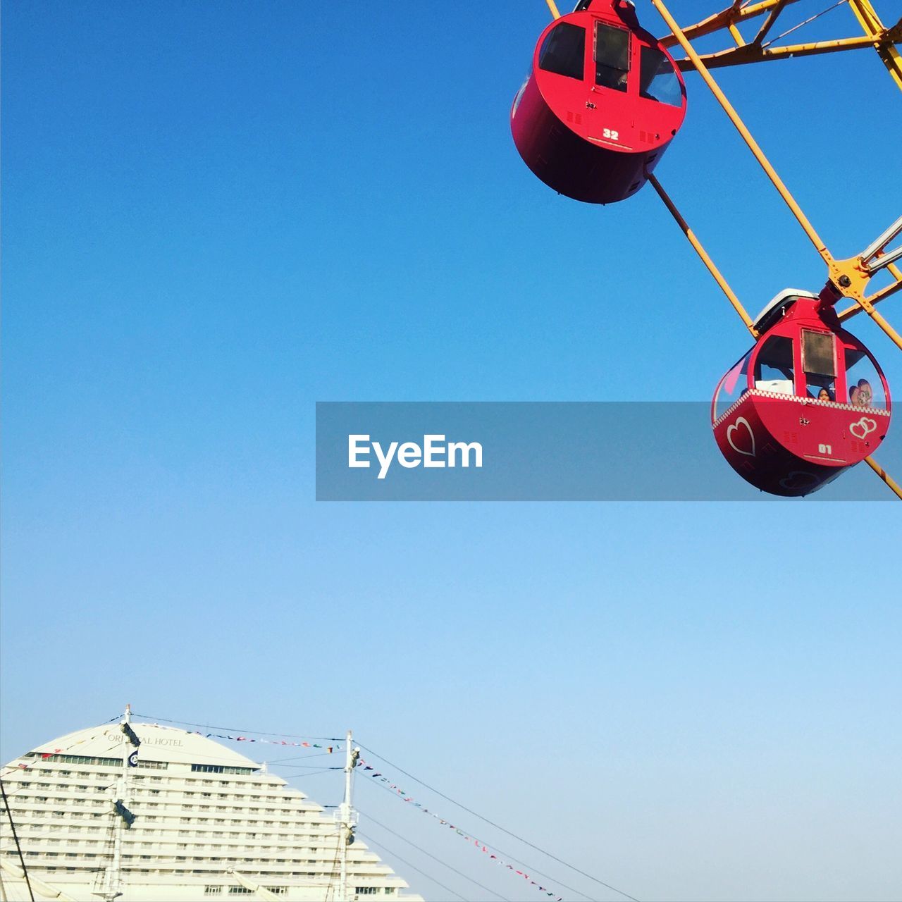 Low angle view of ferris wheel against clear sky