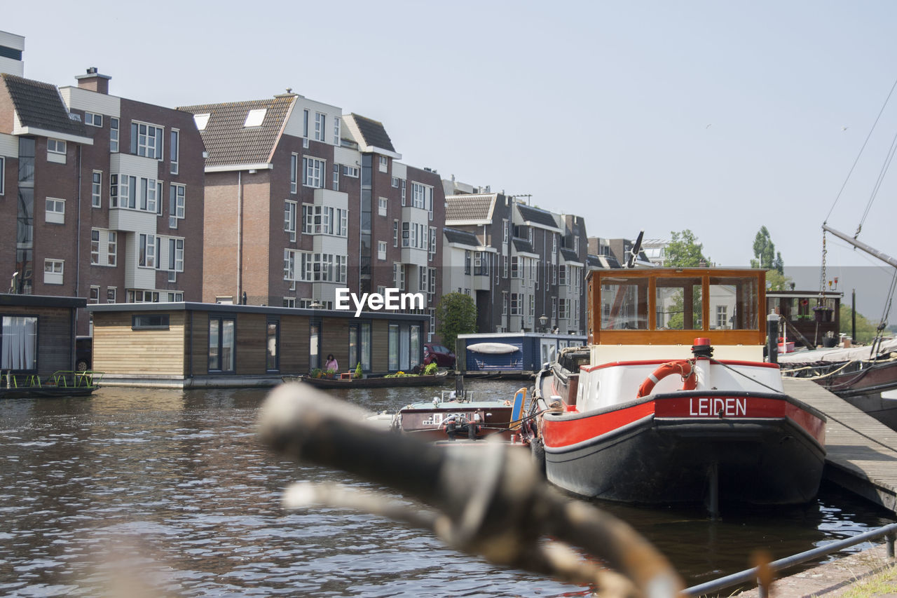 CANAL BY BUILDINGS AGAINST CLEAR SKY