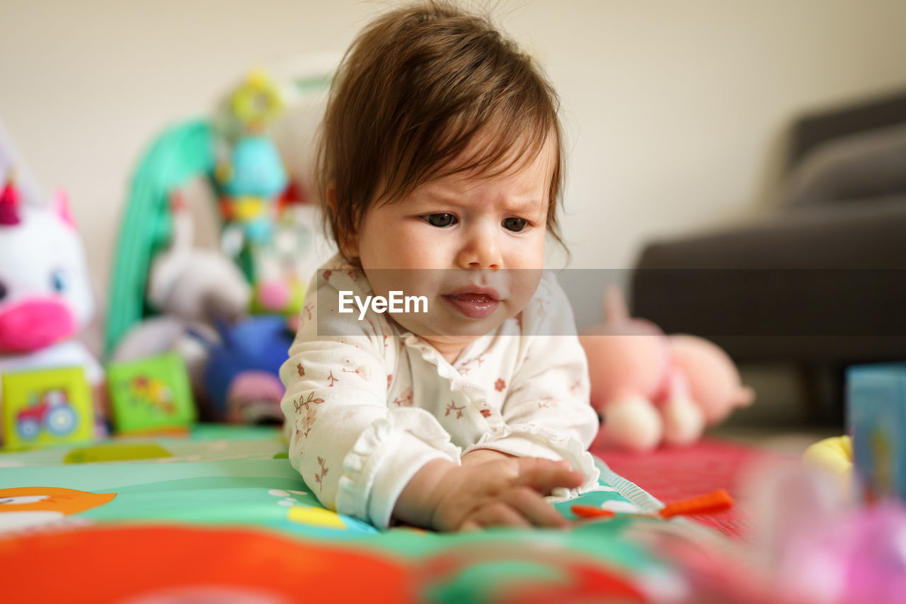 Baby girl playing at home