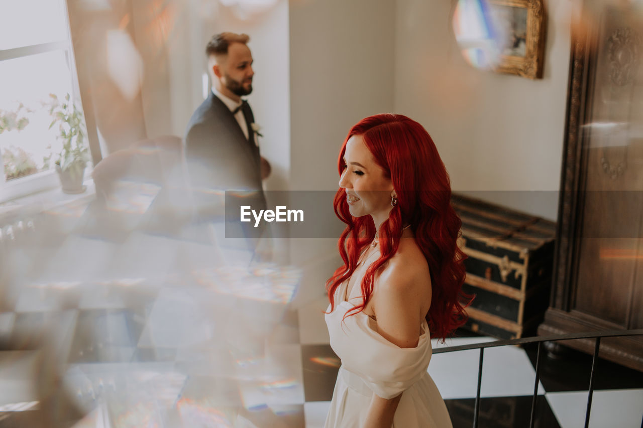 Wedding day. happy bride and groom standing and smiling. red hair diversity