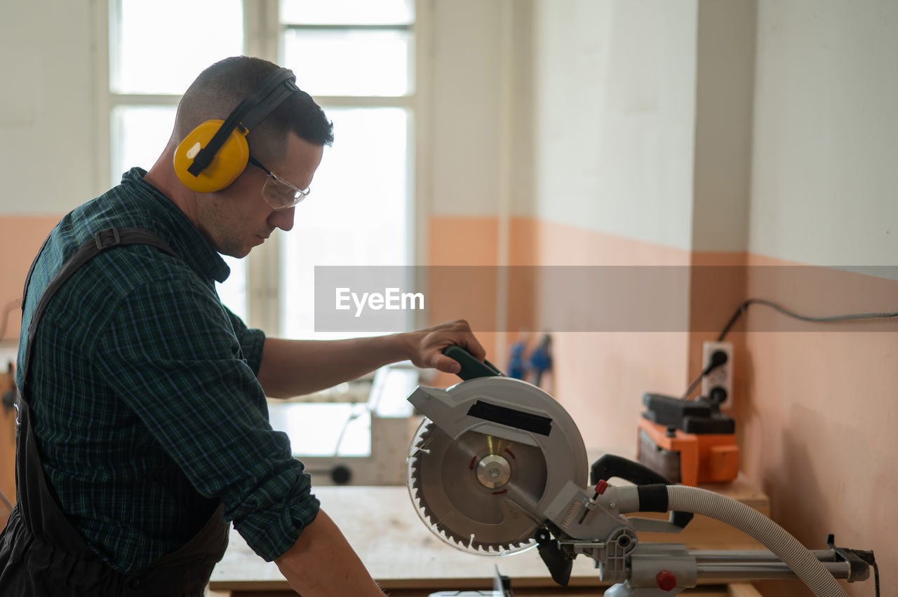 side view of man working in workshop