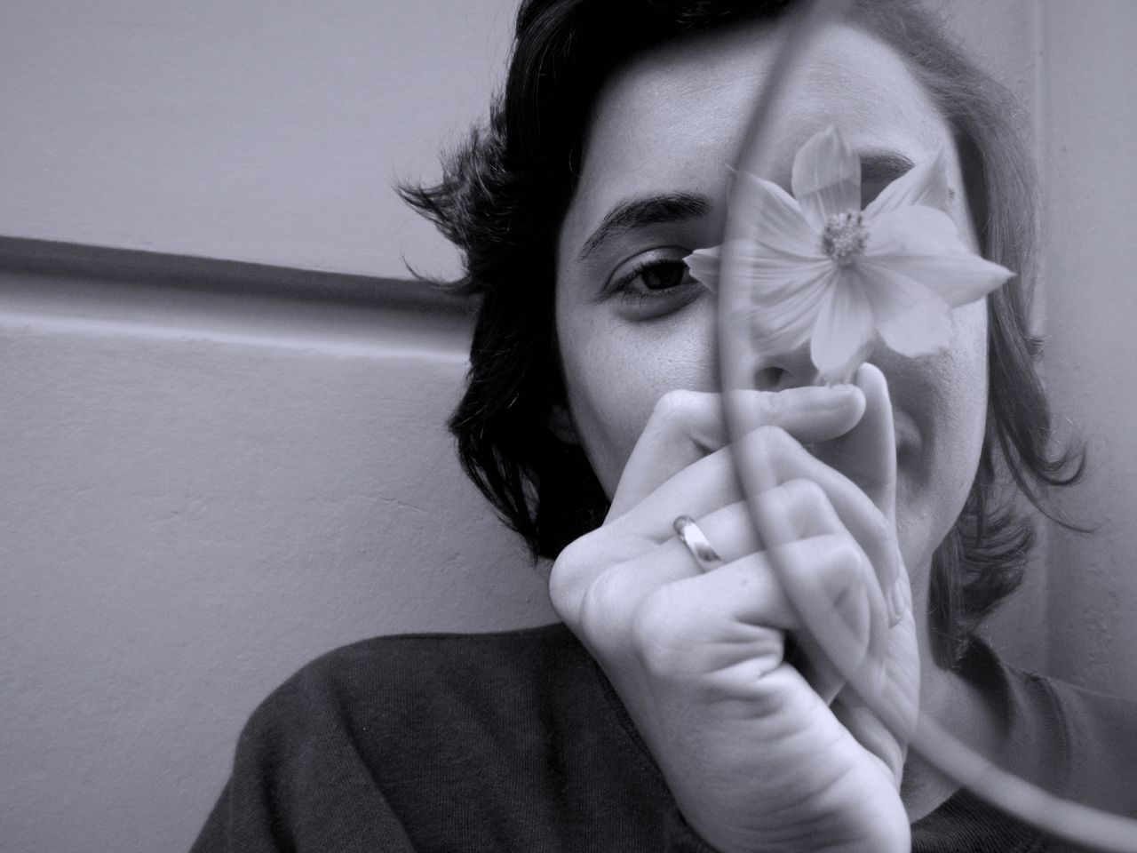 Close-up portrait of woman holding flower