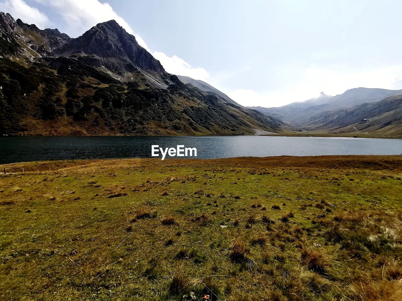 Scenic view of lake and mountains against sky