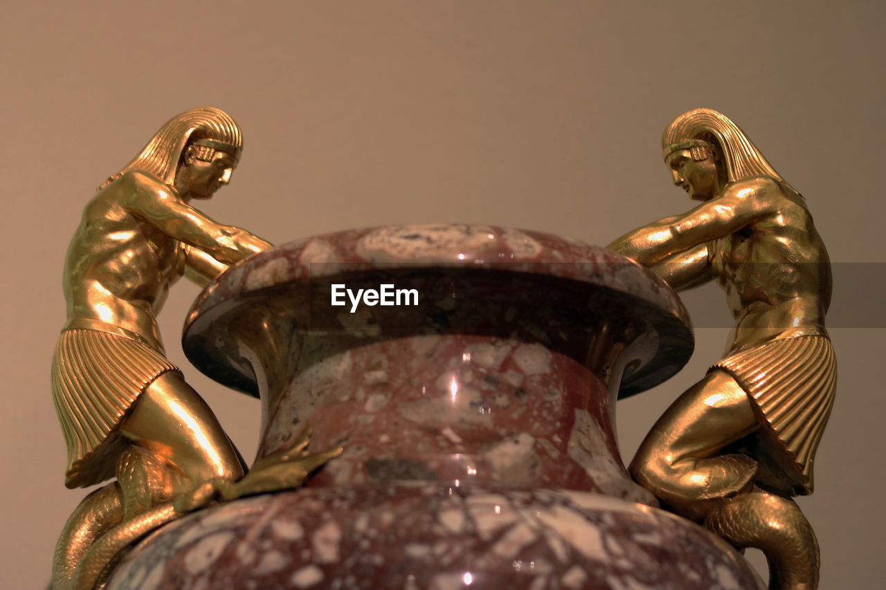 LOW ANGLE VIEW OF BUDDHA STATUE AGAINST METAL