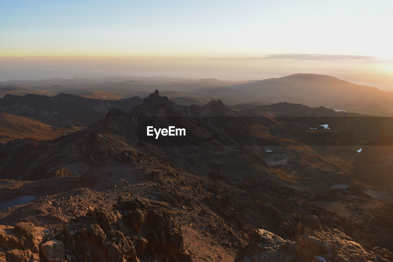 Scenic view of mountains against sky during sunset