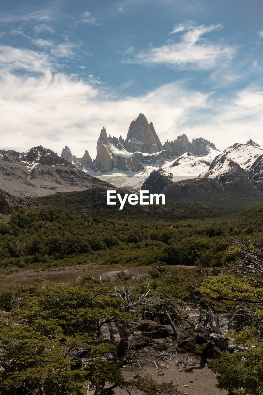 Scenic view of mountains against cloudy sky