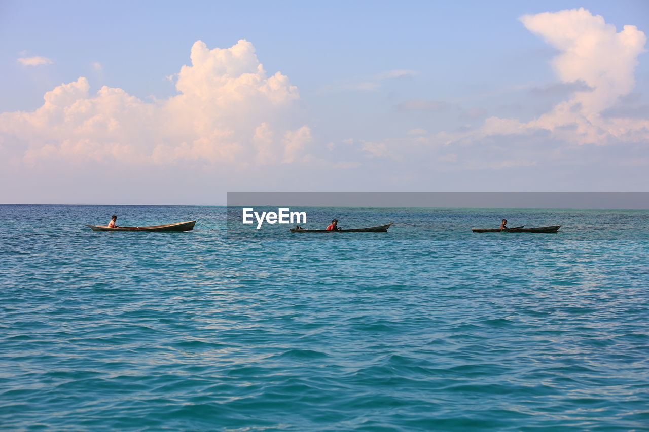 VIEW OF FISHING BOATS IN SEA AGAINST SKY