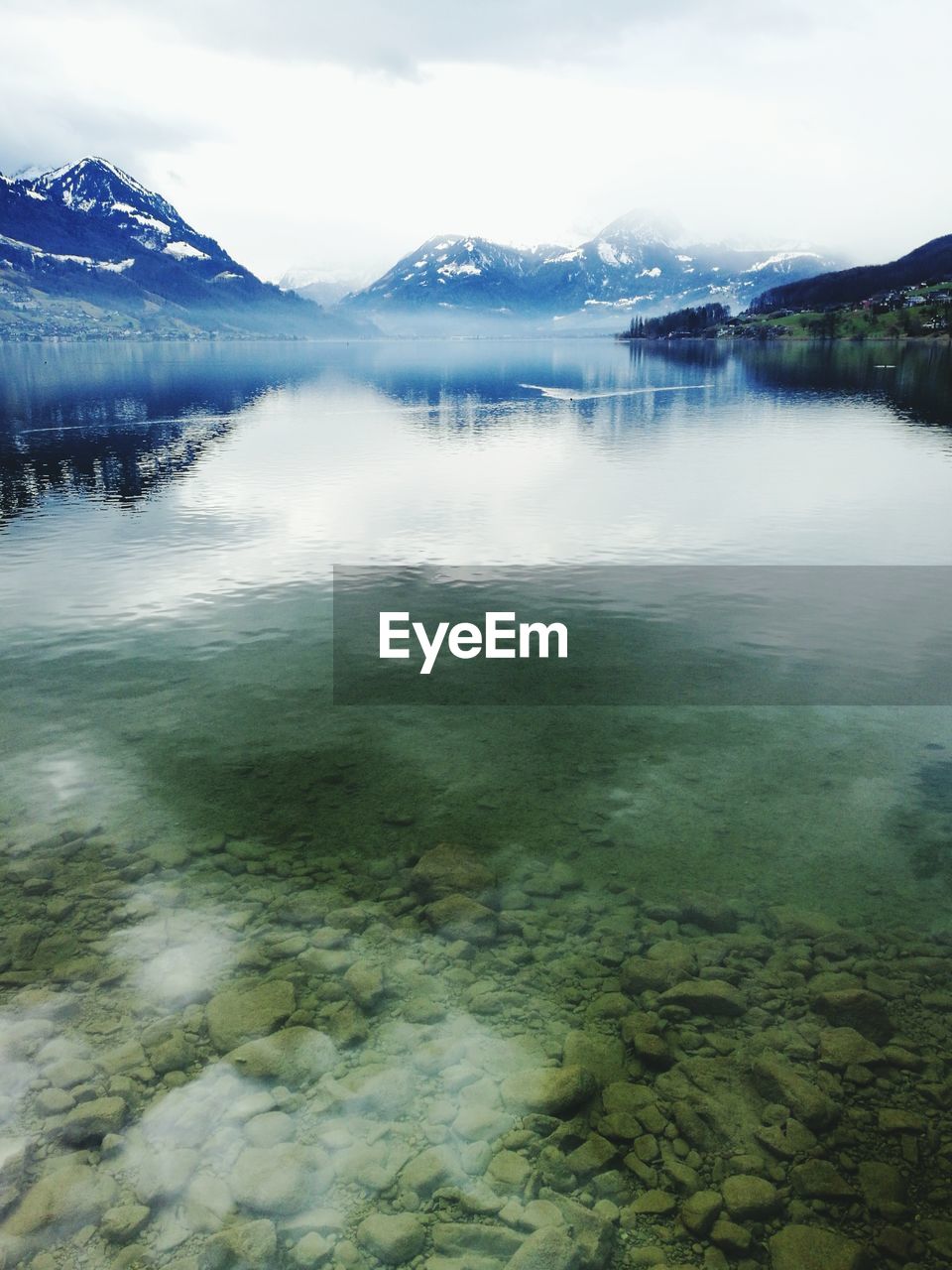 SCENIC VIEW OF LAKE BY MOUNTAIN AGAINST SKY