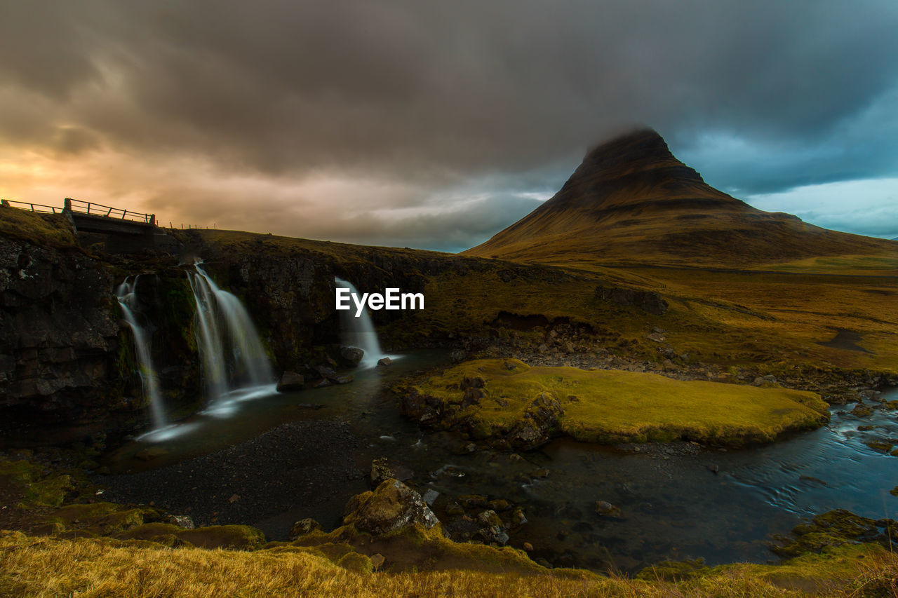 Scenic view of waterfall against sky